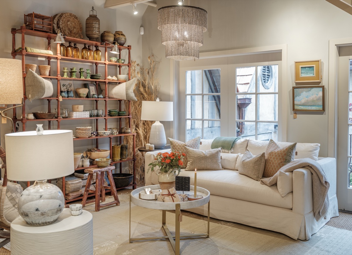 Shop seating area with open shelving, baskets and a chandelier