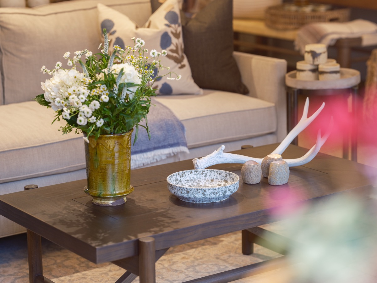 Coffee table styled with fresh flowers and antler decor at the Hart Habitats shop