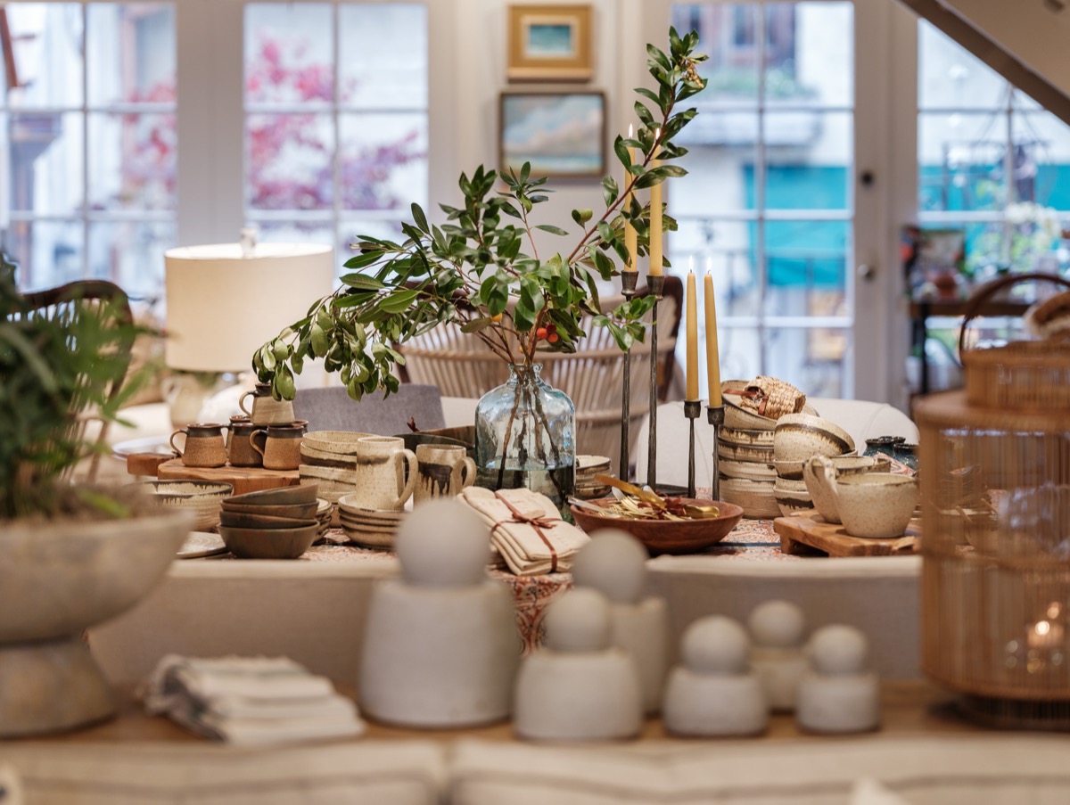 Table styled with ceramic vessels, greenery and woven baskets at the Hart Habitats shop