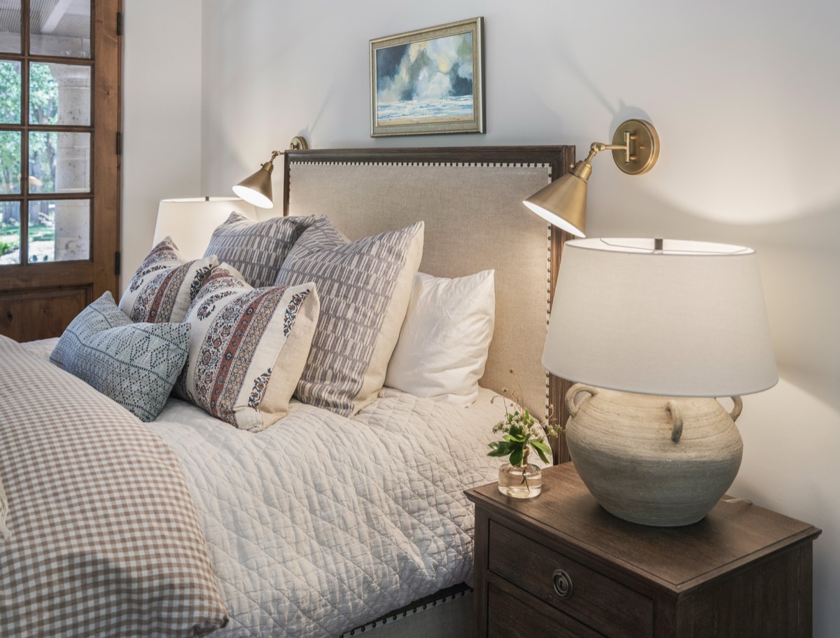 Bedroom with an upholstered headboard and layered pillows
