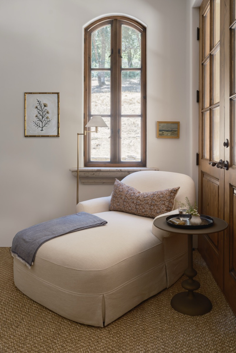 Window-side reading nook with a chaise lounge and blue throw