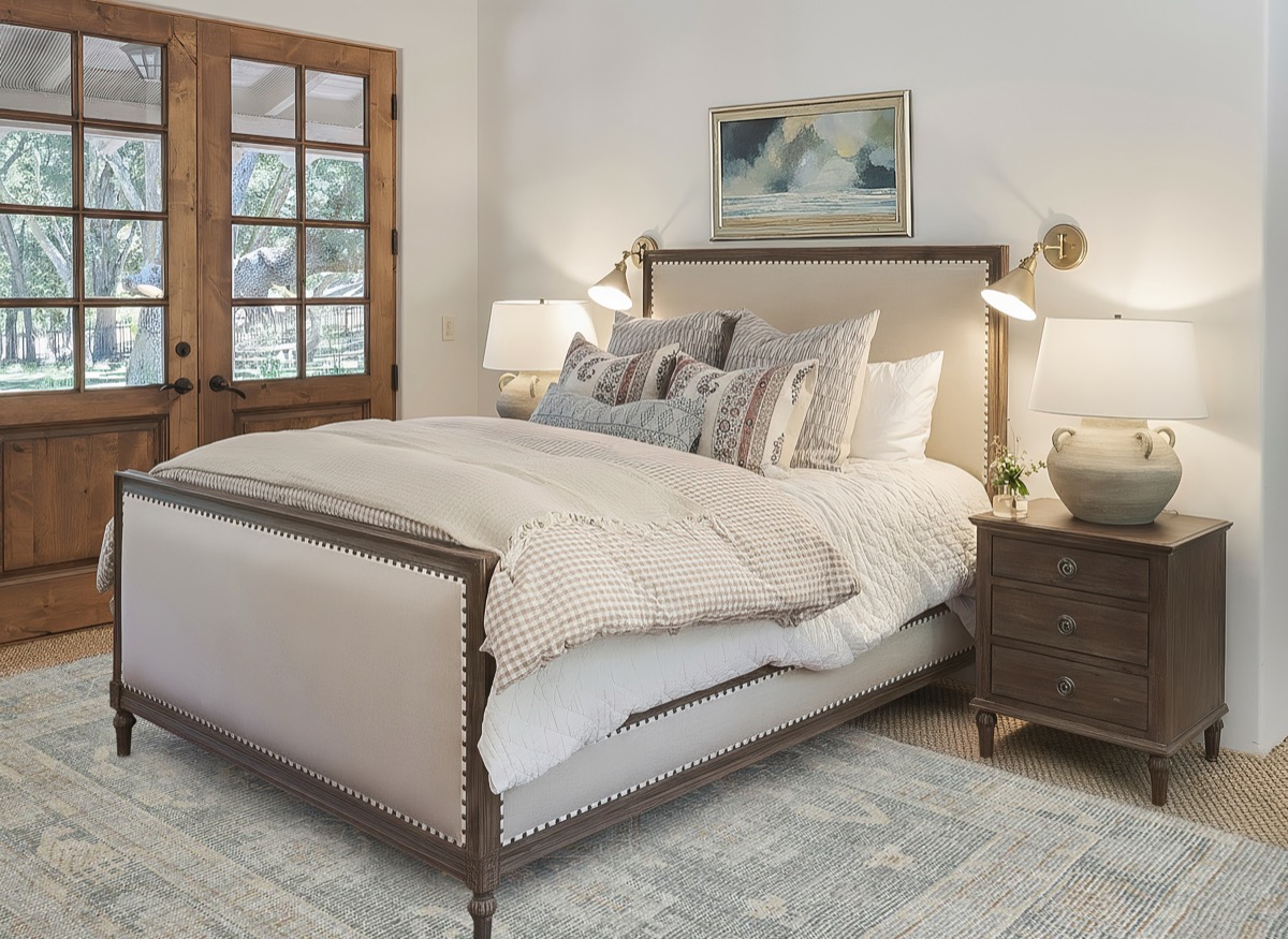 Bedroom with an upholstered bed and French doors to the outdoors